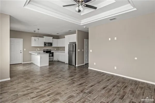 a view of kitchen with stainless steel appliances a refrigerator and a stove top oven