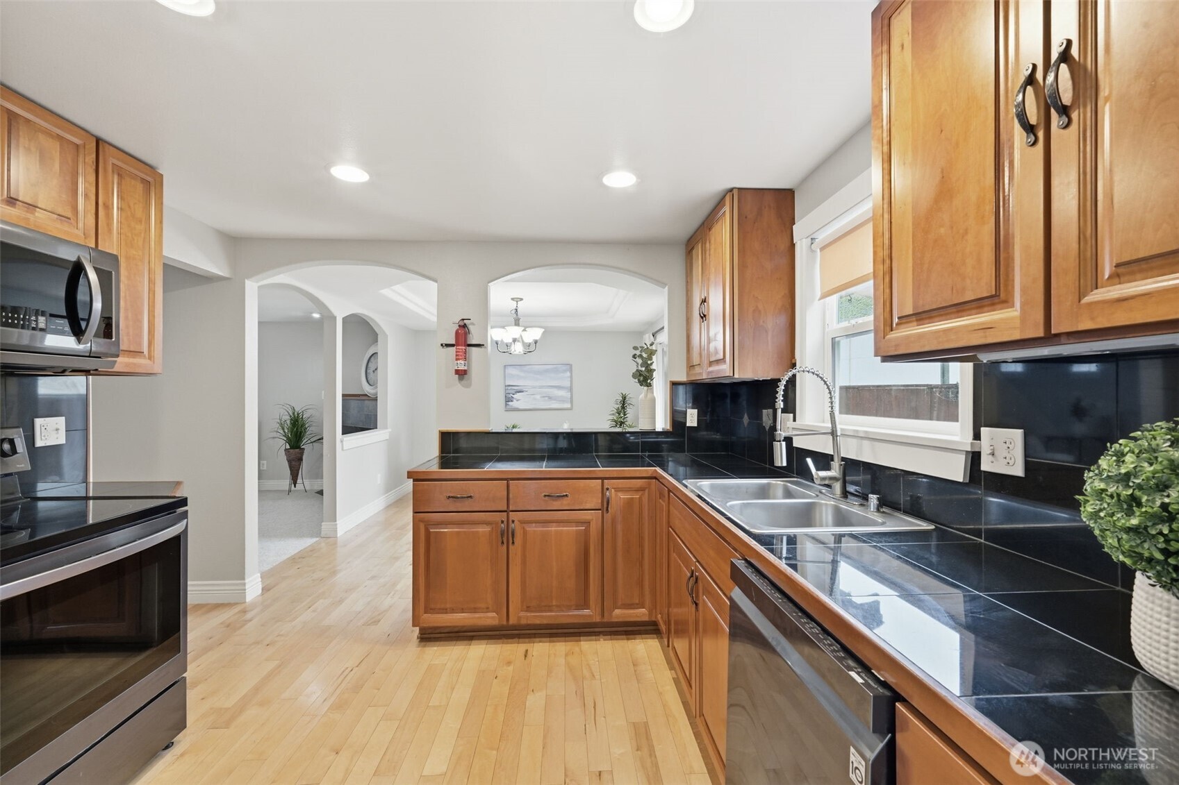 1721 Madison Street, Unit F Everett, WA 98203 - Photo 11 of 36 a kitchen with stainless steel appliances granite countertop a sink stove and cabinets