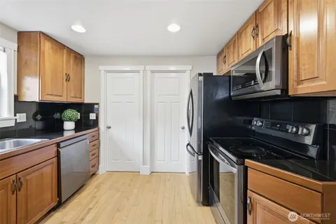 a kitchen with stainless steel appliances granite countertop a stove a sink and a refrigerator