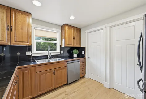 a kitchen with sink cabinets and window