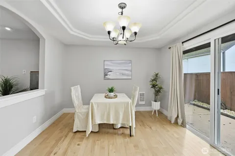 a view of a dining room with furniture wooden floor and a chandelier