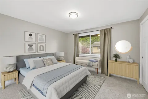 a bedroom with a large bed and a window