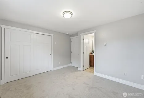 a view of an empty room and closet area