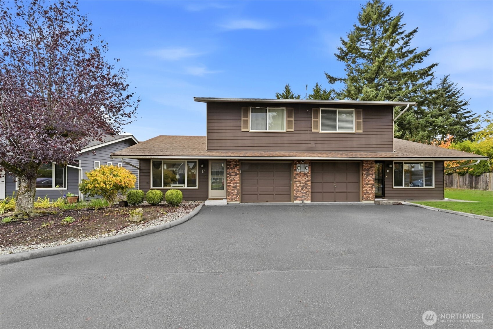1721 Madison Street, Unit F Everett, WA 98203 - Photo 35 of 36 a front view of a house with a garden and trees