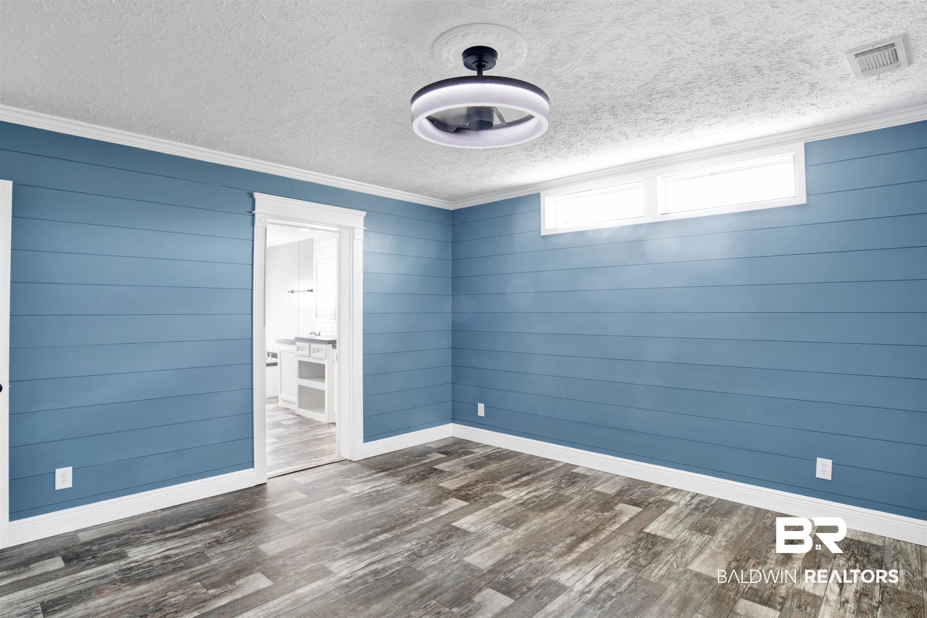 16778 County Road 87 Elberta, AL 36530 - Photo 19 of 32 Empty room featuring ornamental molding, a textured ceiling, and hardwood / wood-style floors