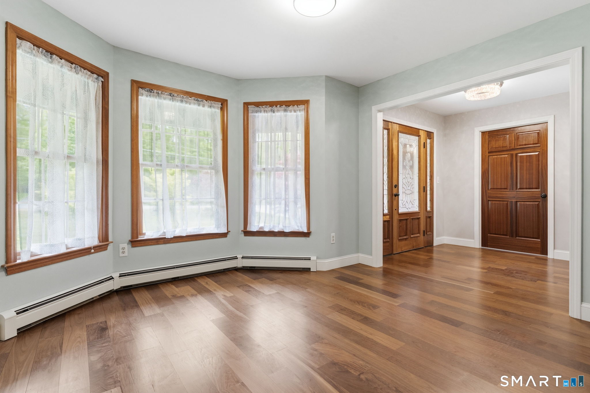287 South Bear Hill Road Chaplin, CT 06235 - Photo 20 of 37 an empty room with wooden floor and windows