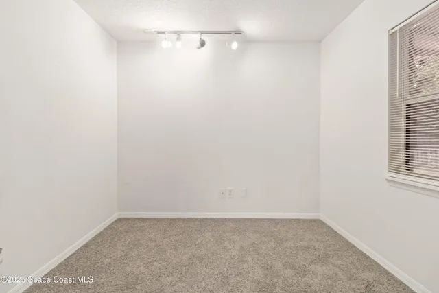 a view of a small space with wooden floor and a window