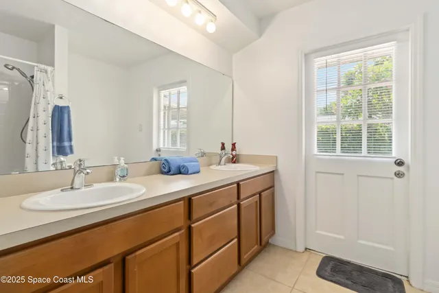 a bathroom with a double vanity sink and a mirror