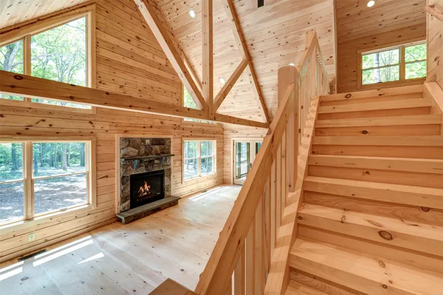 a view of entryway with wooden floor and fireplace