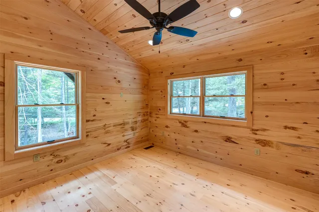 a view of a livingroom with a window and a ceiling fan