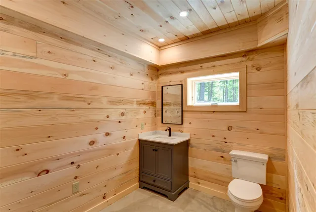 a bathroom with a sink toilet and window