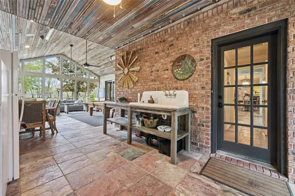 a living room with furniture a window and stainless steel appliances