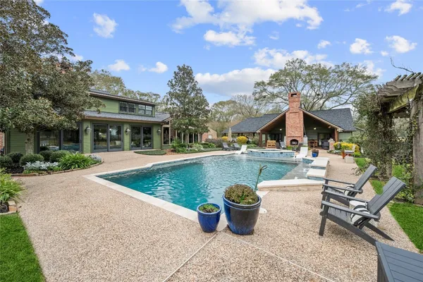 a view of a house with swimming pool and sitting area