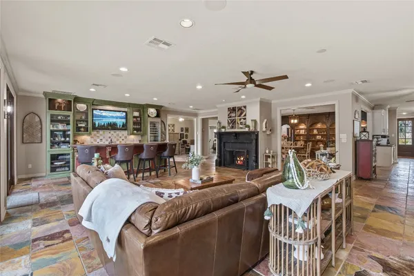 a living room with furniture a wooden floor and a kitchen view