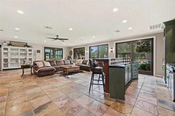 a living room with furniture and a dining table with projector the view