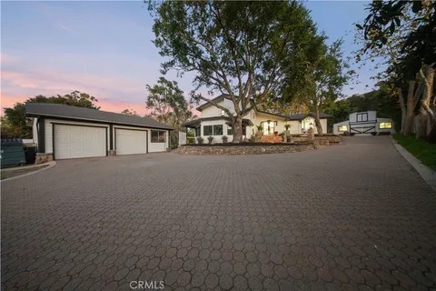 an aerial view of a house with a yard basket ball court and outdoor seating