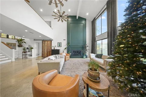 a large kitchen with stainless steel appliances granite countertop a lot of counter space and wooden floors