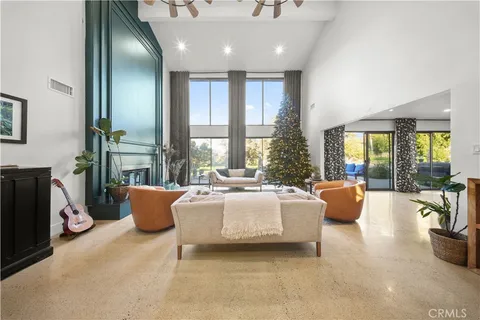 a view of living room with furniture and a mirror