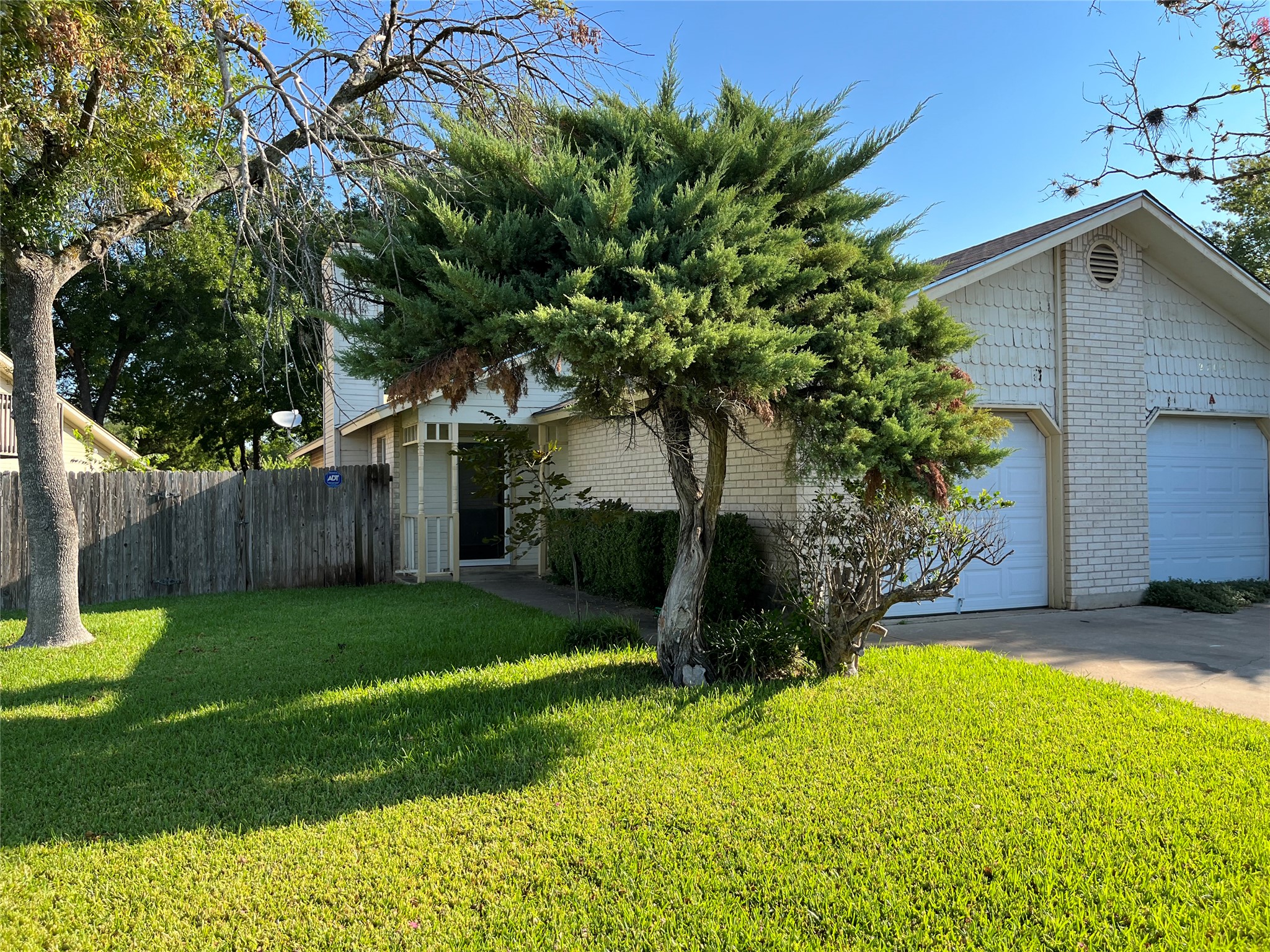 2704 Aftonshire Way, Unit B Austin, TX 78748 - Photo 1 of 1 Obstructed view of property with brick siding and concrete driveway