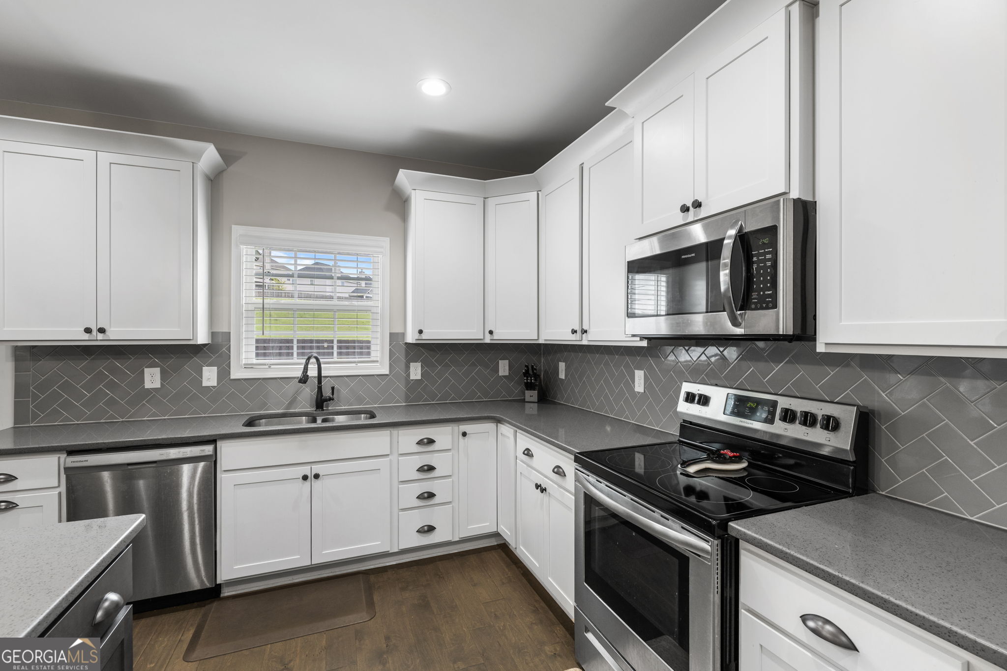 413 Shoshone Circle Kathleen, GA 31047 - Photo 16 of 42 a kitchen with stainless steel appliances white cabinets granite counter tops and a window