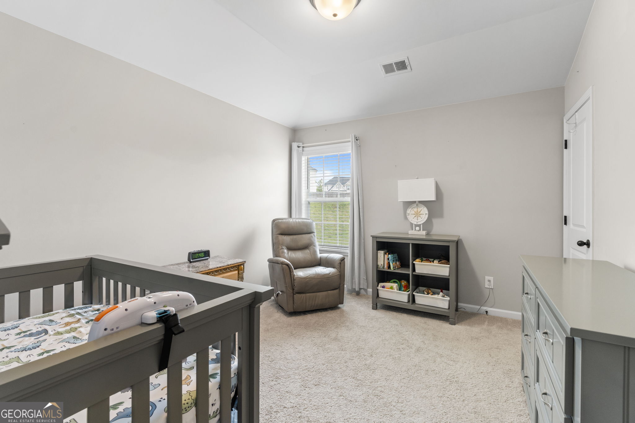 413 Shoshone Circle Kathleen, GA 31047 - Photo 21 of 42 a bedroom with furniture and a book shelf