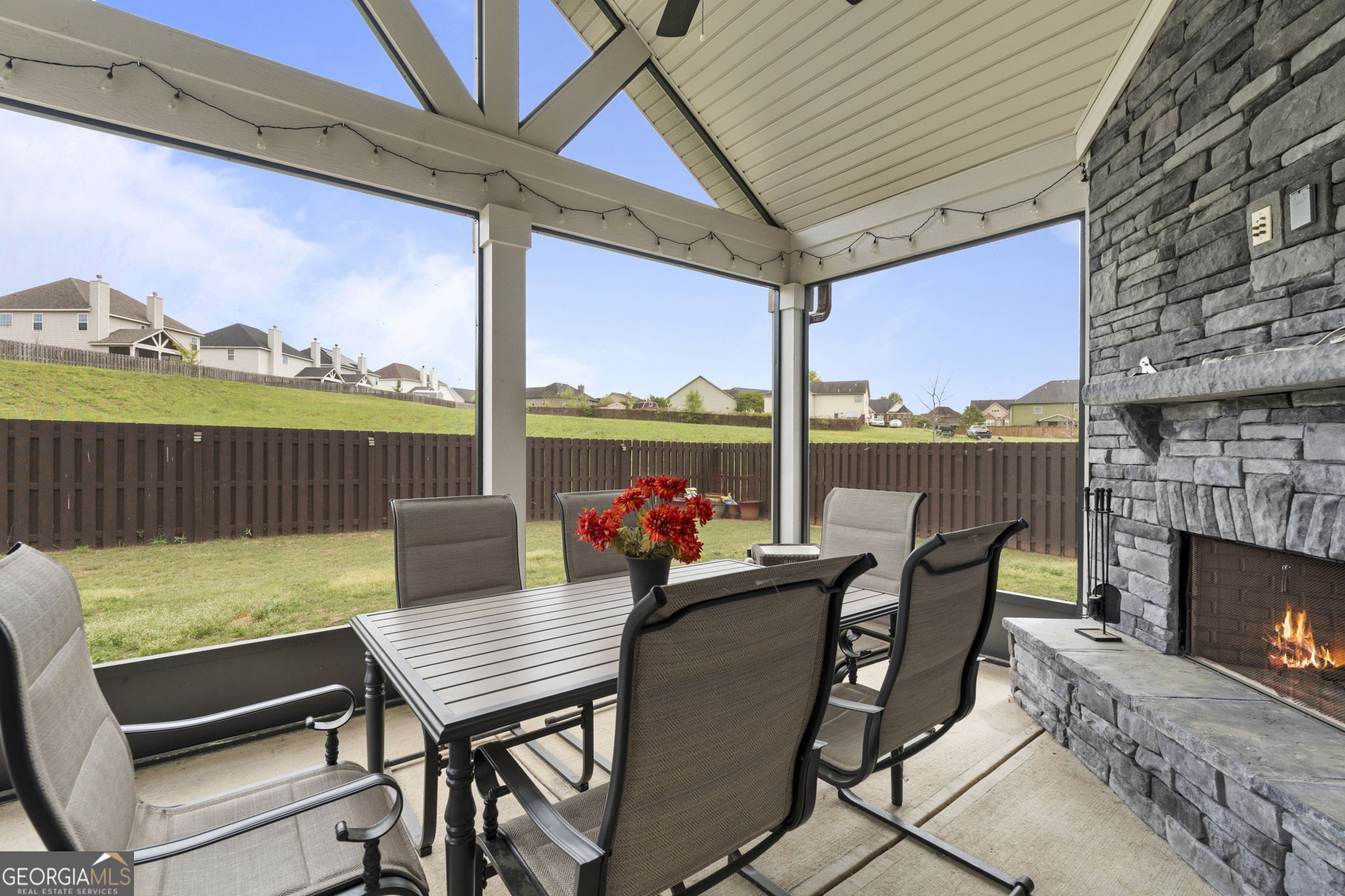 413 Shoshone Circle Kathleen, GA 31047 - Photo 38 of 42 a view of a patio with a table chairs and a fireplace