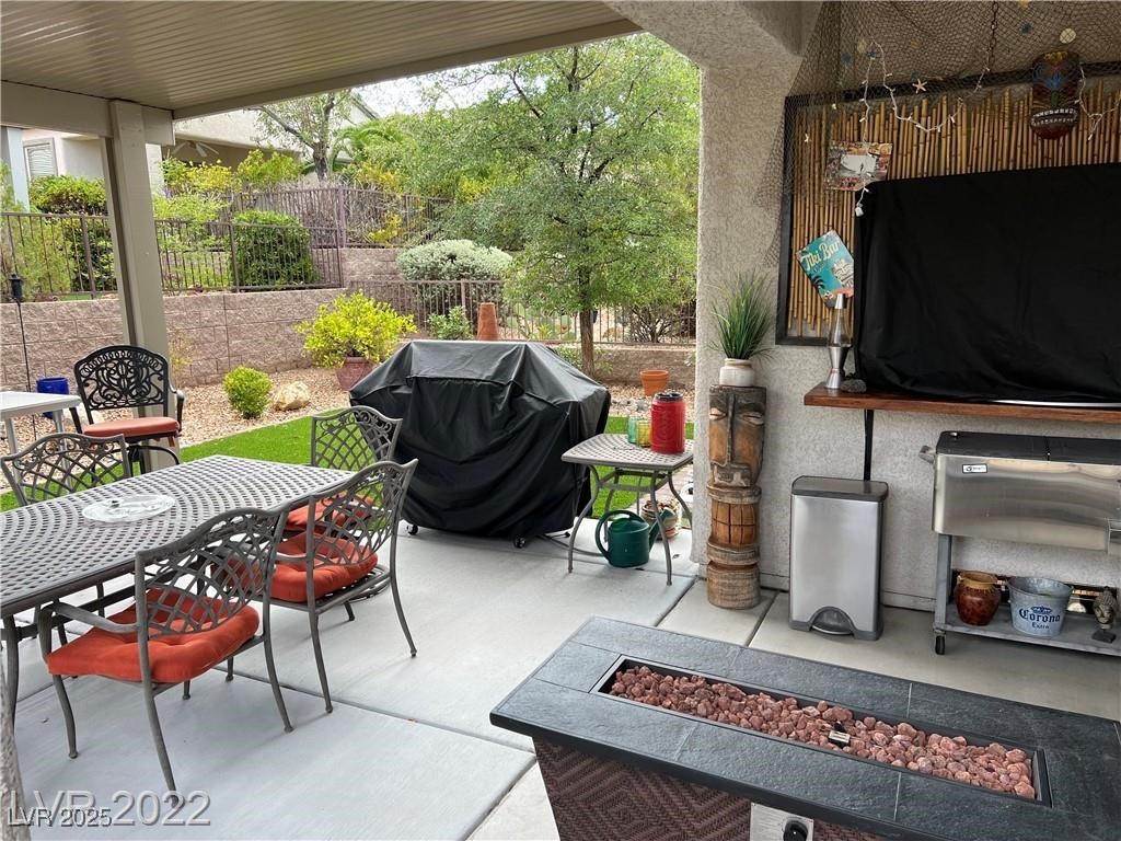 2556 Anani Road Henderson, NV 89044 - Photo 13 of 32 View of patio / terrace with grilling area, outdoor dining space, and an outdoor fire pit
