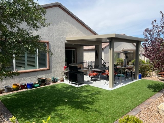 2556 Anani Road Henderson, NV 89044 - Photo 9 of 32 Back of property featuring a patio, a lawn, stucco siding, and a gazebo