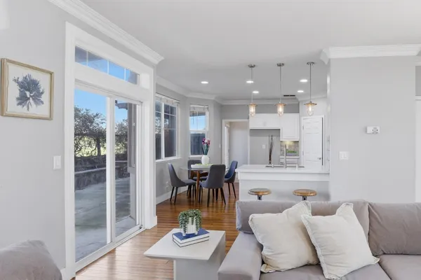 a living room with furniture and wooden floor