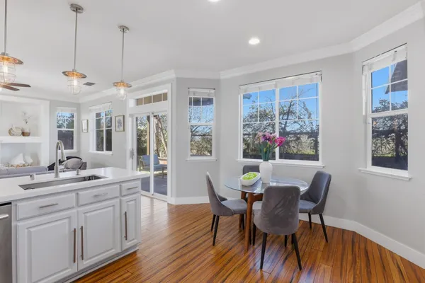 a view of a dining room with furniture window and wooden floor