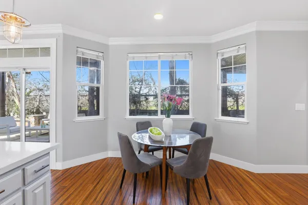 a view of a dining room with furniture window and wooden floor