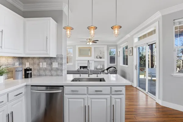 a kitchen with a sink stove and cabinets