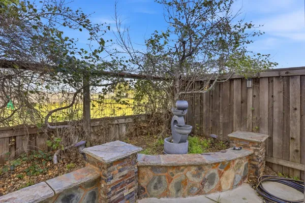 a view of a chair and table in backyard