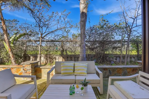 a view of a chair and tables in the patio