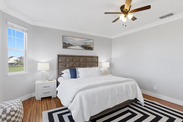 a bedroom with a bed and a chandelier