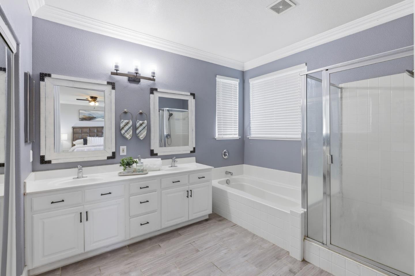 609 Rockspray Circle Pittsburg, CA 94565 - Photo 29 of 43 a bathroom with a double vanity sink a large mirror a shower and bathtub
