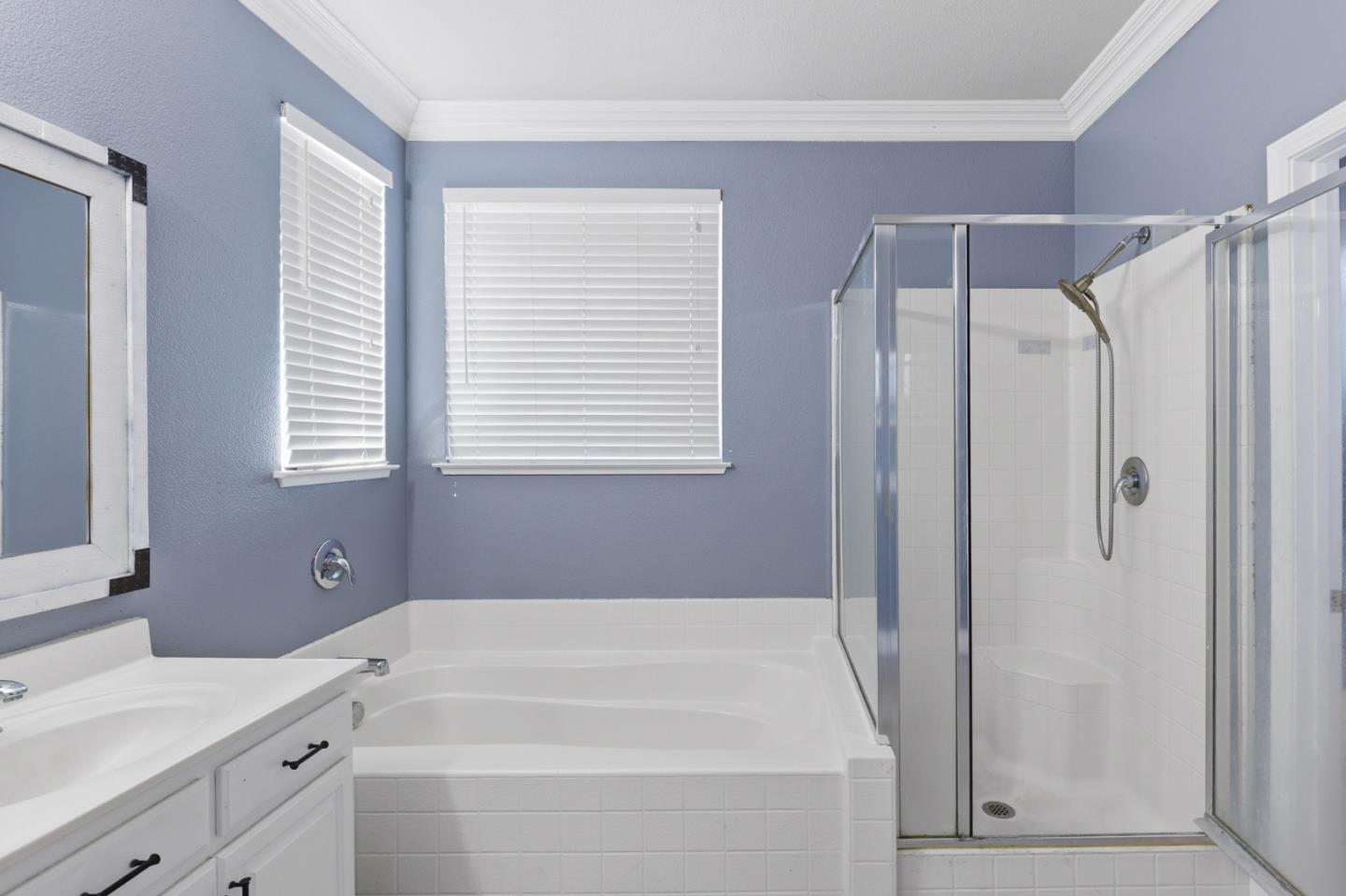 609 Rockspray Circle Pittsburg, CA 94565 - Photo 33 of 43 a bathroom with a bathtub a shower a sink and a window