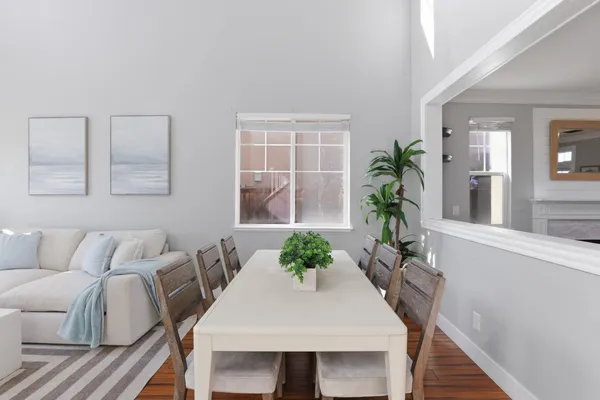 a view of a dining room with furniture and wooden floor