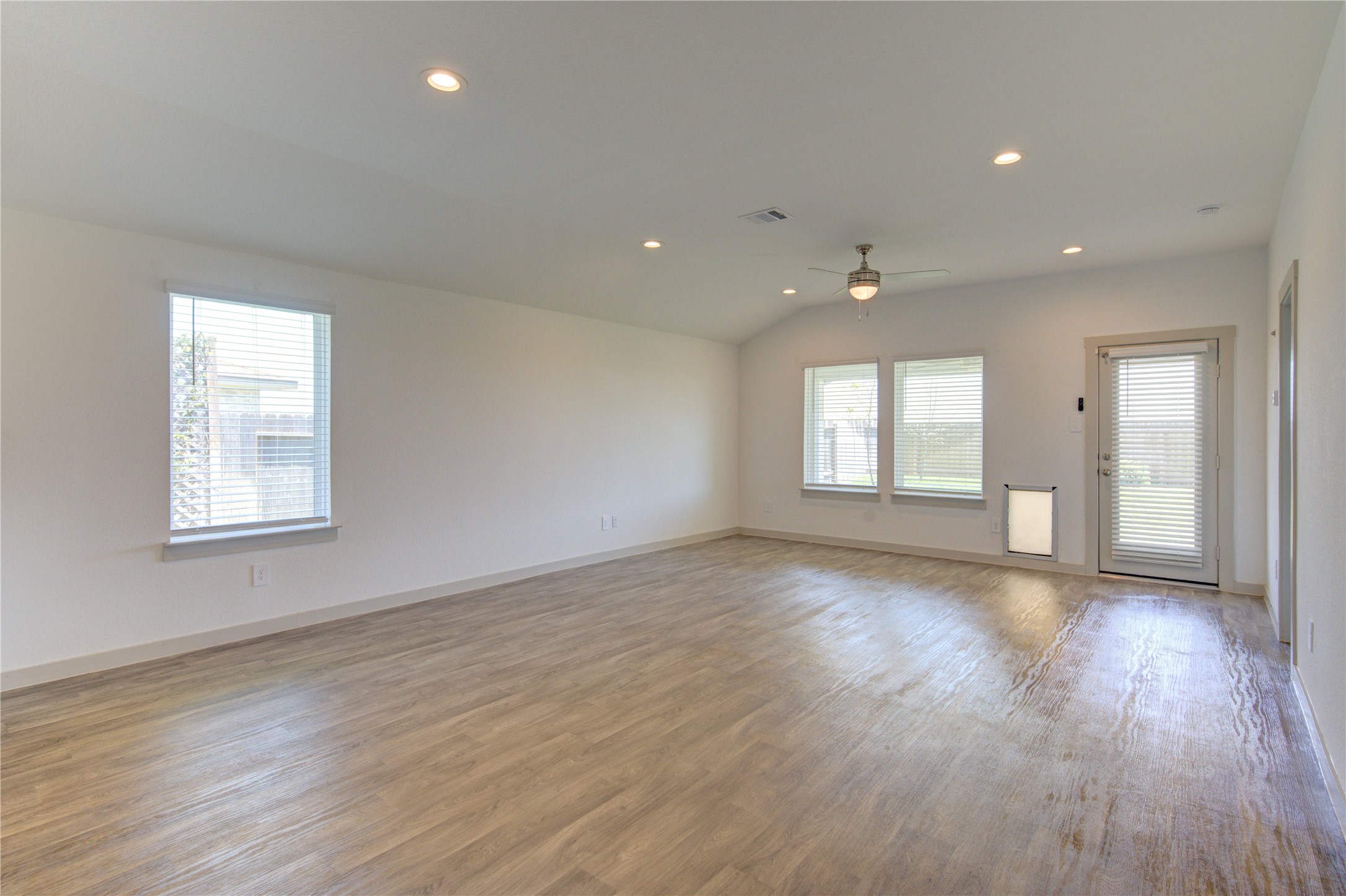41 Desert Spring Lane Manvel, TX 77578 - Photo 14 of 33 an empty room with wooden floor and windows
