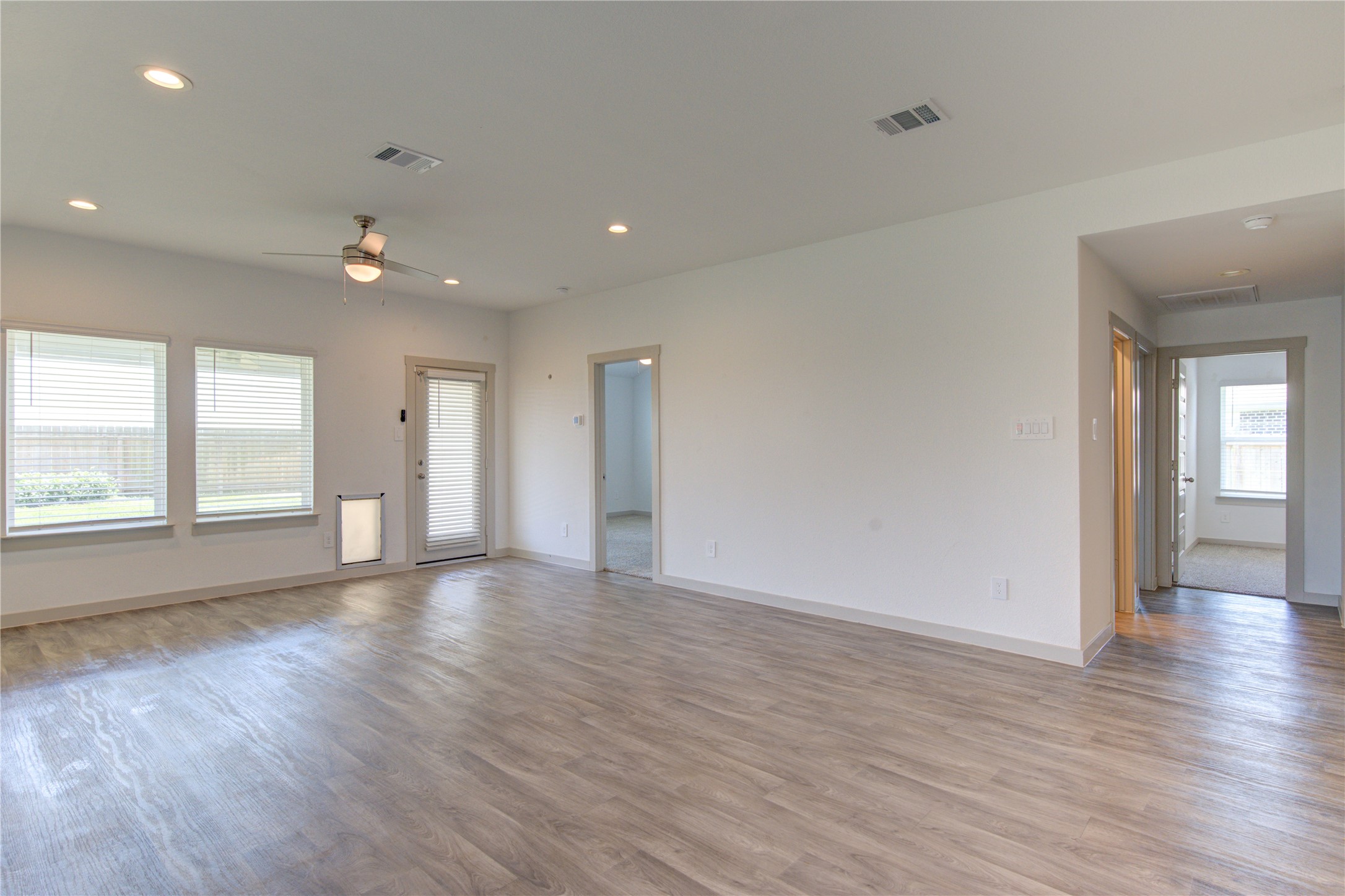 41 Desert Spring Lane Manvel, TX 77578 - Photo 16 of 33 a view of an empty room with wooden floor and a window