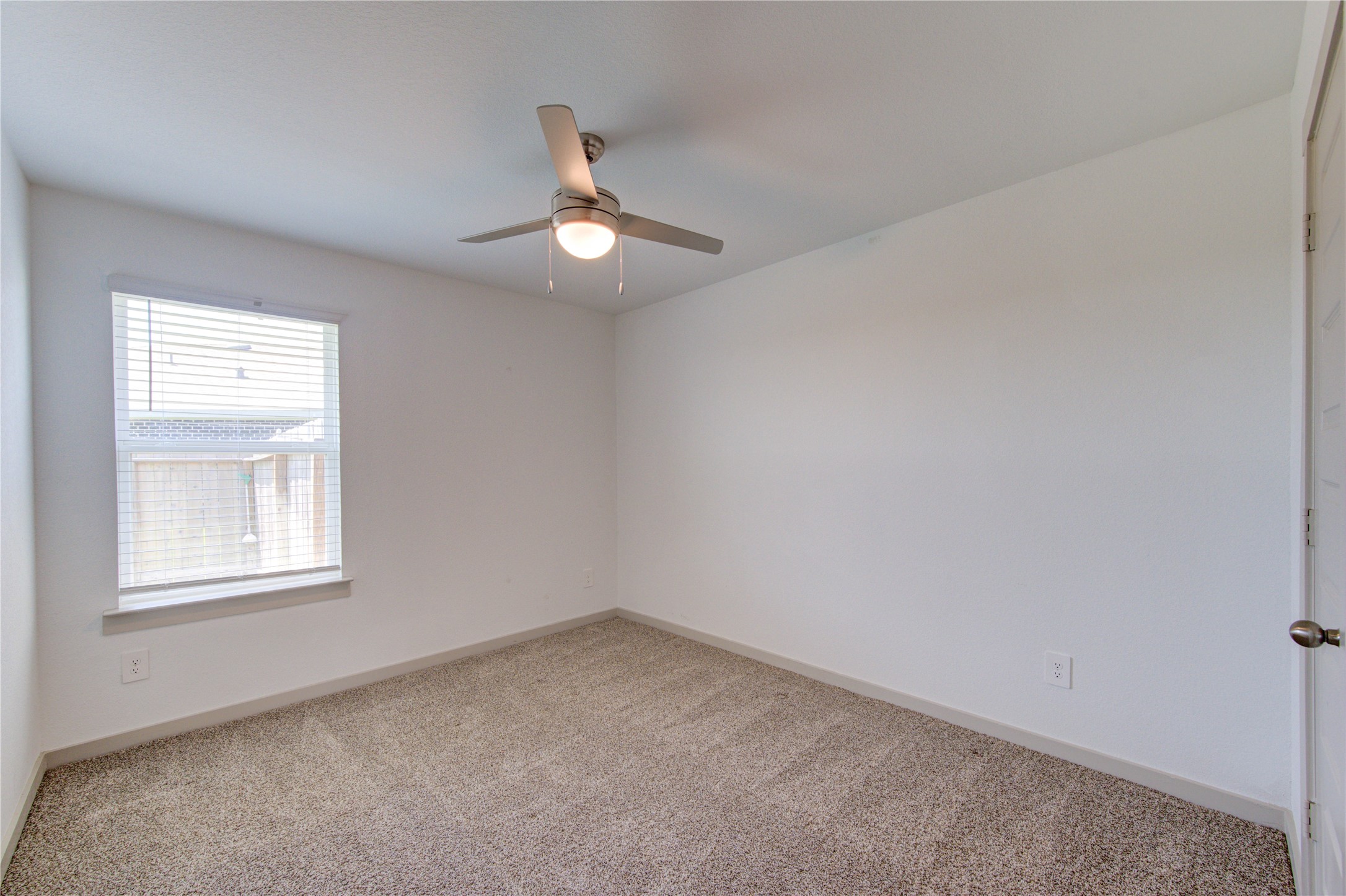 41 Desert Spring Lane Manvel, TX 77578 - Photo 23 of 33 an empty room with a window and ceiling fan