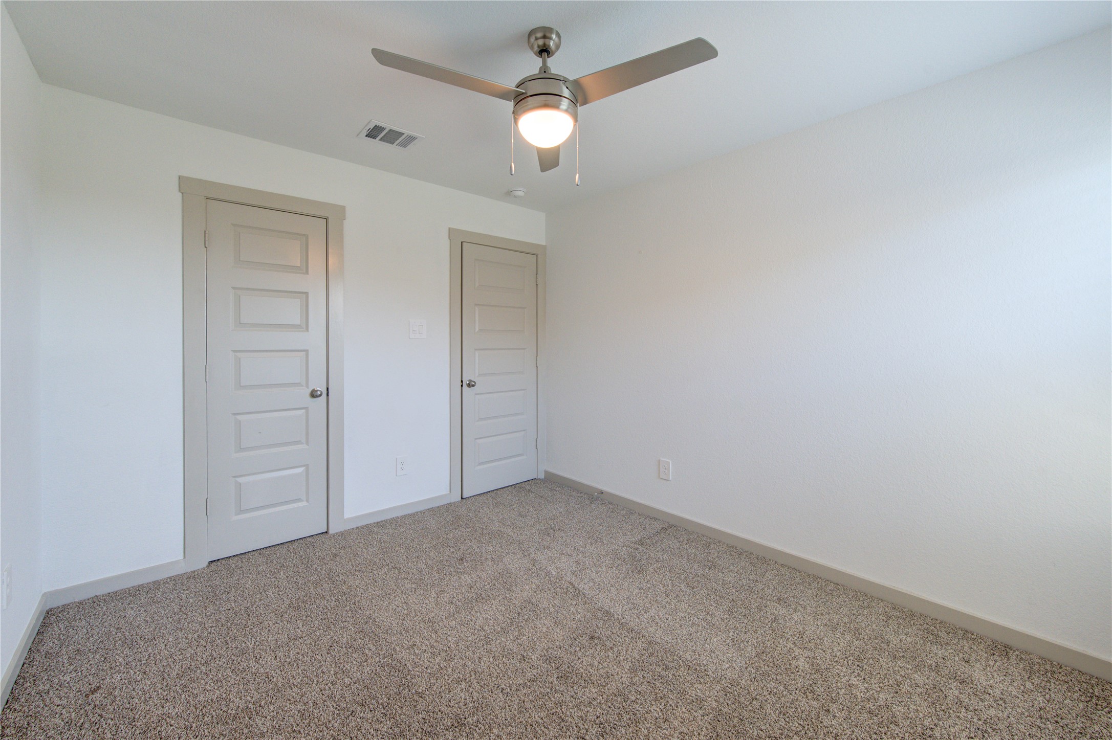 41 Desert Spring Lane Manvel, TX 77578 - Photo 24 of 33 an empty room with closet and a chandelier fan