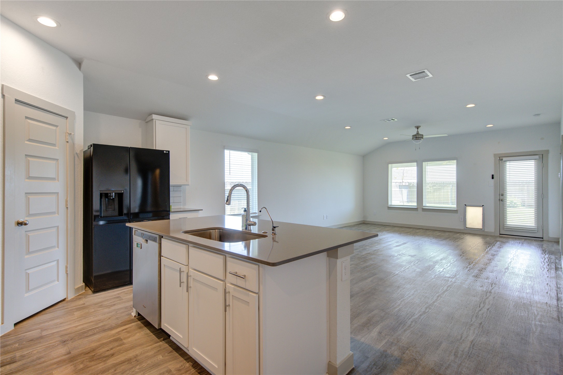 41 Desert Spring Lane Manvel, TX 77578 - Photo 9 of 33 a kitchen with stainless steel appliances granite countertop a sink and dishwasher with wooden floor