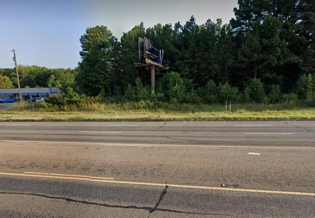 a view of a yard and tree