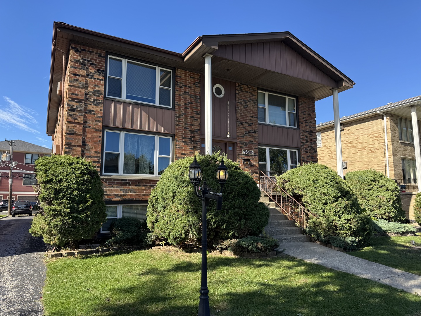 4512 Grove Avenue, Unit 1N Brookfield, IL 60513 - Photo 1 of 10 a front view of a house with a yard