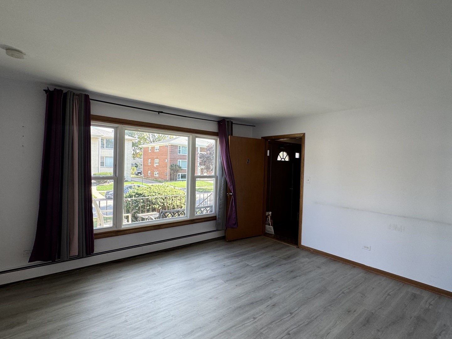 4512 Grove Avenue, Unit 1N Brookfield, IL 60513 - Photo 3 of 10 an empty room with wooden floor and windows