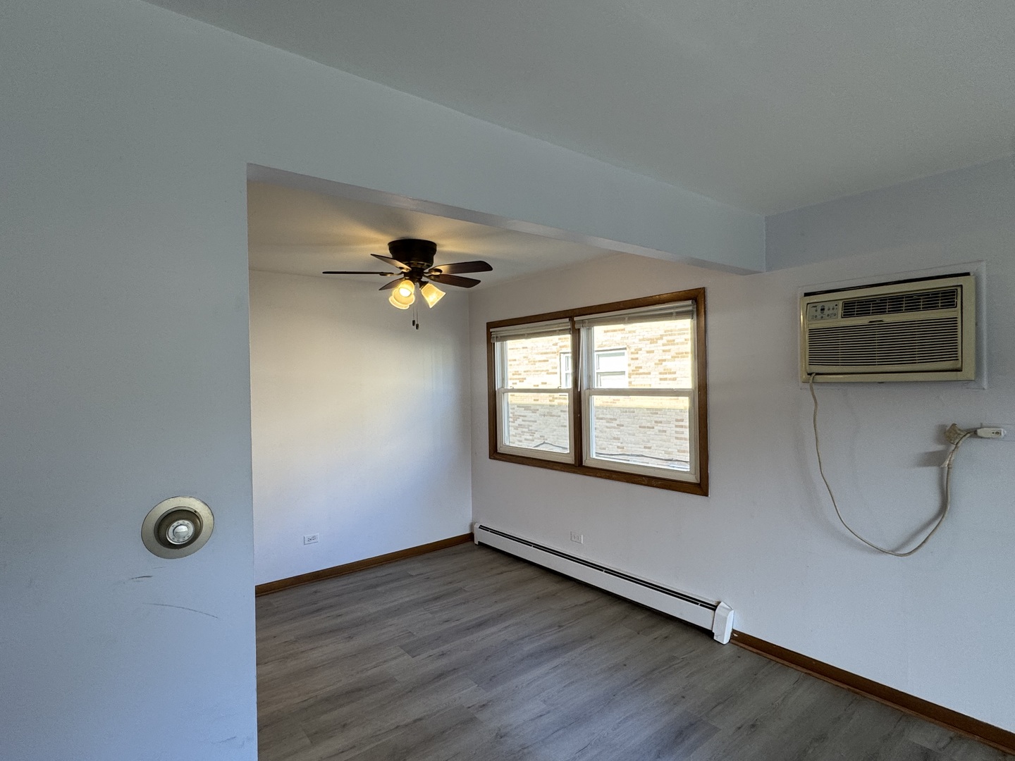4512 Grove Avenue, Unit 1N Brookfield, IL 60513 - Photo 4 of 10 a view of a room with wooden floor and windows