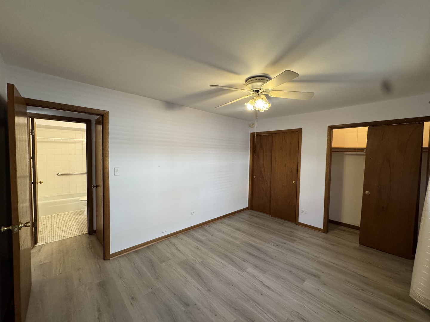 4512 Grove Avenue, Unit 1N Brookfield, IL 60513 - Photo 9 of 10 an empty room with wooden floor and a ceiling fan
