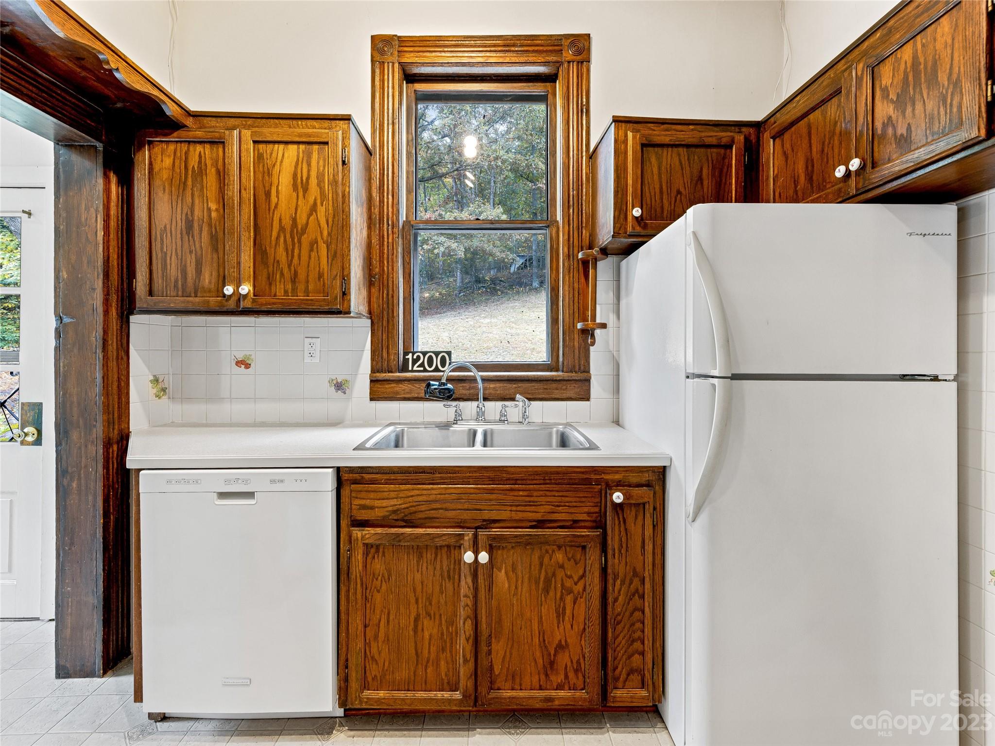 1200 Redmon Road Marshall, NC 28753 - Photo 12 of 37 a kitchen with a refrigerator and a sink