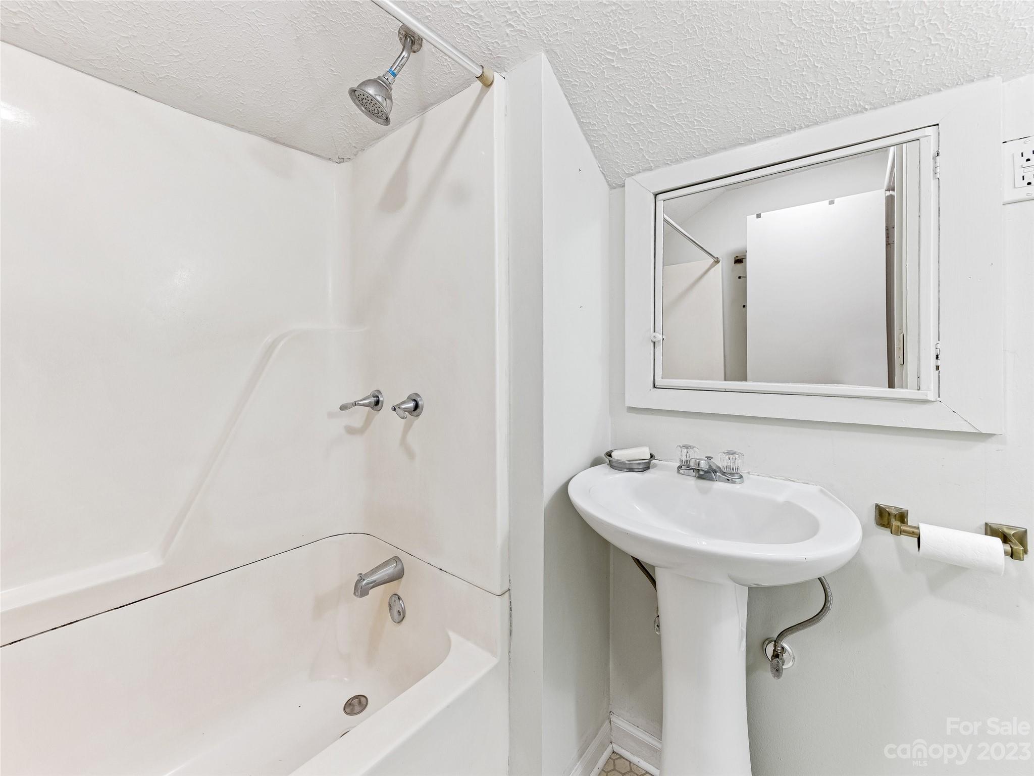 1200 Redmon Road Marshall, NC 28753 - Photo 29 of 37 a white bath tub sitting next to a white sink